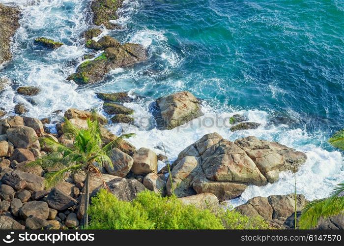 Rocky coast and clear turquoise sea. Thiruvananthapuram, India