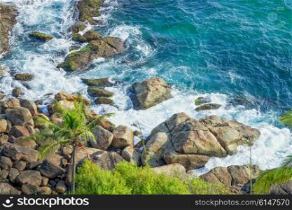 Rocky coast and clear turquoise sea. Thiruvananthapuram, India