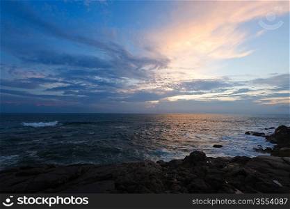 Rocky coast at sunset. Unawatuna, Sri Lanka