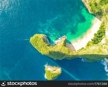 Rocky coast of a tropical island. Empty beach and small island. Sunny weather. Aerial view. Peninsula with an Empty Beach and a Small Island. Aerial View