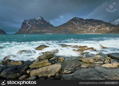 Rocky coast of fjord of Norwegian sea in winter. Lofoten islands, Norway. Rocky coast of fjord in Norway