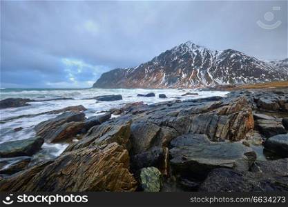 Rocky coast of fjord of Norwegian sea in winter. Lofoten islands, Norway. Rocky coast of fjord in Norway