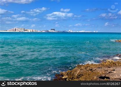 Rocky coast, the sea and city in the distanceMexico. Cancun
