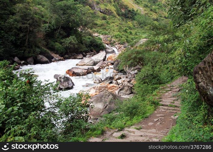 Rocky footpath and mountain river in Nepal