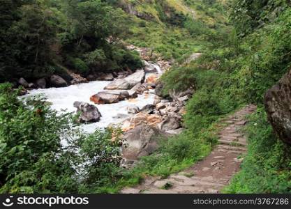 Rocky footpath and mountain river in Nepal