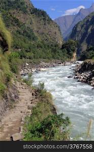 Rocky footpath near mountain river in Nepal