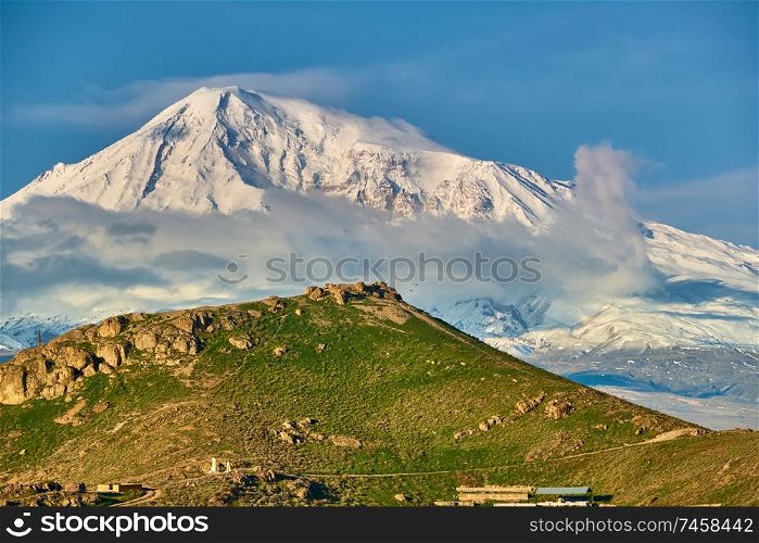 Rocky hill landscape at morning in Armenia with Ararat mountain at background
