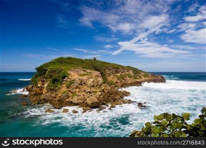 Rocky island in surf off the north east coast of Puerto Rico