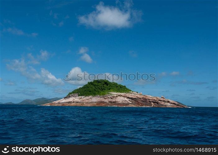 Rocky island with sea on the horizon and blue sky. Booby rock Island, Praslin, Seychelles