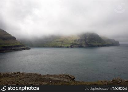 Rocky landscape on the Faroe Islands. Rocky landscape on the Faroe Islands with cliff and ocean