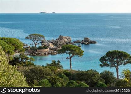 Rocky outcrop , islands and coastline near Palombaggia beach in Corsica with blue skies and a calm Mediterranean sea