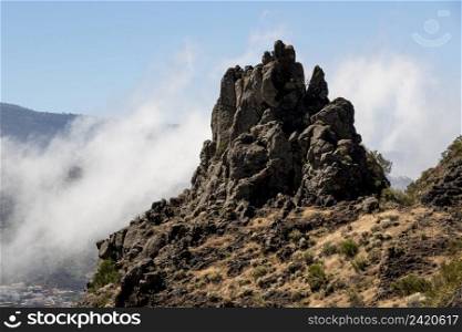 rocky peak surrounded by clouds