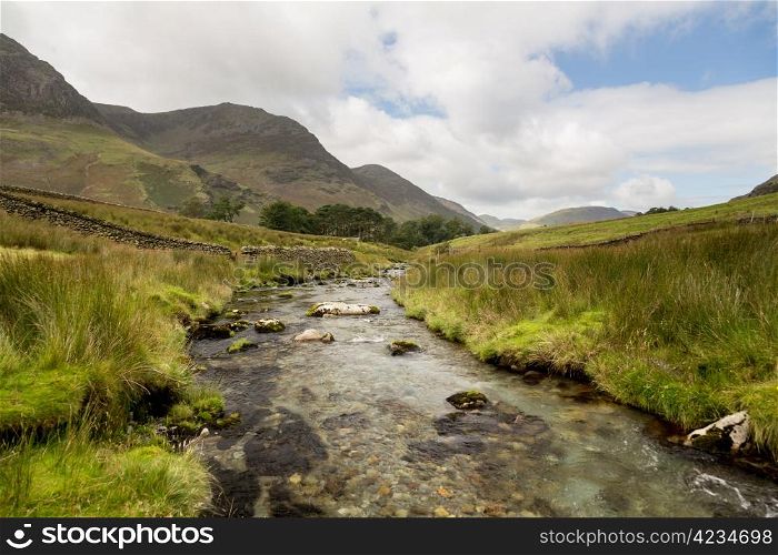 Rocky river leads to Buttermere over Honister Pass in English lake District