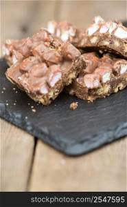 Rocky road squares on rustic background