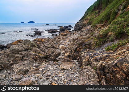 Rocky shore and Brisons Rock in distance at Cape Cornwall