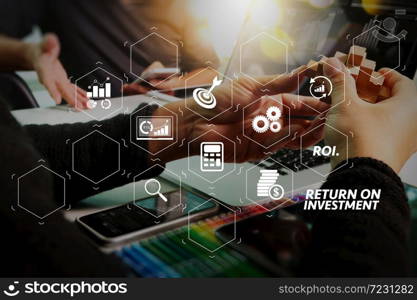 ROI Return on Investment indicator in virtual dashboard for improving business. two colleague web designer discussing data and digital tablet and computer laptop with smart phone and design diagram on marble desk.