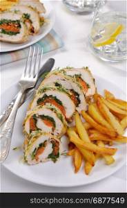Roll from chicken breast with spinach and carrots under a crust of parmesan, dill, garnish of french fries