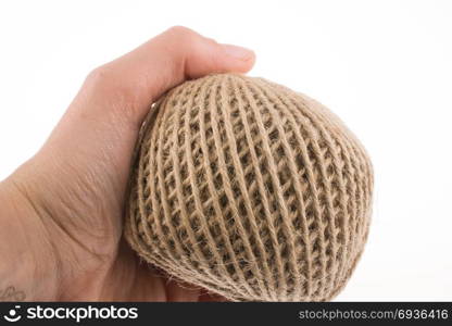 Roll of brown color linen string on a white background