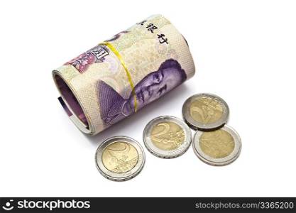 Roll of chinese money and euro coins closeup on white background