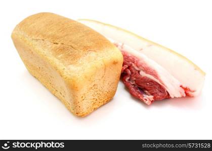 Roll of fresh bread and the big piece of fat with meat on a white background