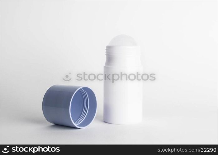 Roll-on antiperspirant cosmetic and blue cover isolated on white background. Roll-on antiperspirant isolated white background