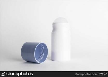 Roll-on antiperspirant cosmetic and blue cover isolated on white background. Roll-on antiperspirant isolated white background