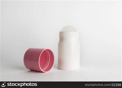 Roll-on antiperspirant cosmetic and pink cover isolated on white background. Roll-on antiperspirant isolated white background