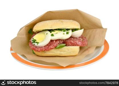 Roll sausage with oxen sausage and egg on a white background.