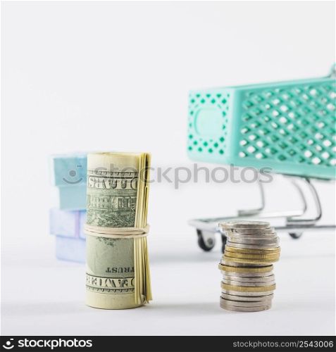 rolled dollars coins stack white table