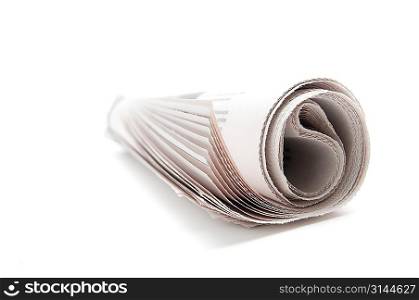 Rolled newspaper on white background