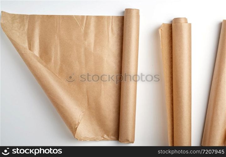 rolled rolls of parchment baking paper on a white background, top view