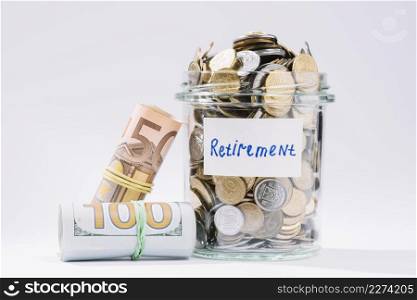 rolled up banknotes retirement container full coins white background. Resolution and high quality beautiful photo. rolled up banknotes retirement container full coins white background. High quality beautiful photo concept