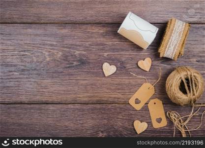 rolled up lace wooden heart shape tags jute spool wooden desk