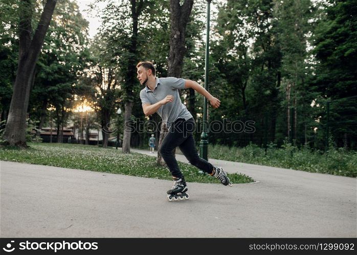Roller skating, male skater rolling in action. Urban roller-skating, active extreme sport outdoors, youth leisure, rollerskating. Roller skating, male skater rolling in action