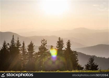 Rolling forest hills silhouettes with sunlight glares landscape photo. Beautiful nature scenery photography. Ambient light. High quality picture for wallpaper, travel blog, magazine, article. Rolling forest hills silhouettes with sunlight glares landscape photo