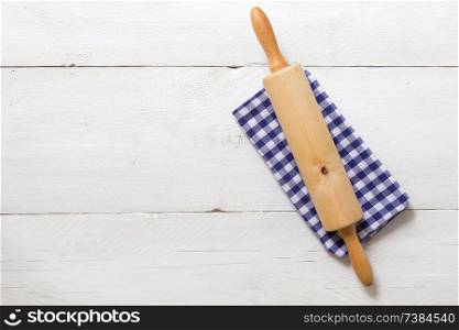 Rolling pin and dishcloth on rustic wooden background.. Rolling pin and dishcloth on rustic wooden background