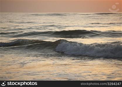 Rolling waves on the ocean in the evening glow