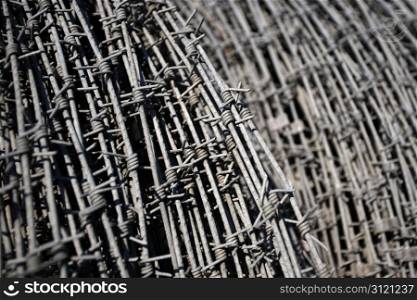 Rolls of barbed wire stacked in an army base.