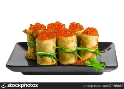 rolls of pancakes with caviar on black plate isolated