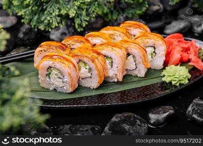 Rolls with fried salmon and cheese, cucumber on plate