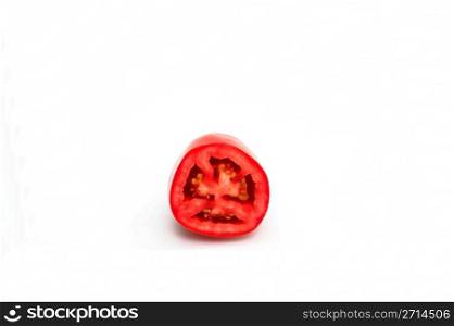 Roma Tomato. Close-up of a Roma tomato sliced in half showing the seeds and flesh inside isolated on white
