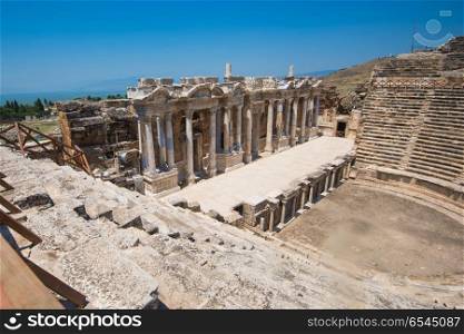 Roman amphitheatre in the ruins of Hierapolis. Roman amphitheatre in the ruins of Hierapolis, in Pamukkale, near modern turkey city Denizli, Turkey.