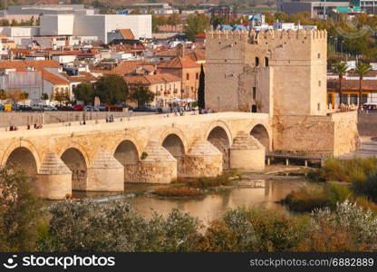 Roman bridge and Calahorra Tower, Cordoba, Spain. Puente Romano or Roman bridge across Guadalquivir river and Torre de Calahorra or Calahorra Tower in sunny day, Cordoba, Andalusia, Spain