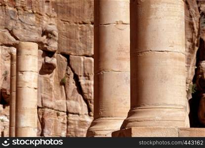 Roman columns next to the Nabataean amphitheatre in the rock town and necropolis of Petra , Jordan, middle east