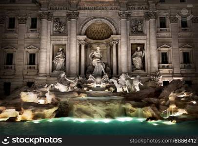 Roman Fountain di Trevi illuminated at night, Italy