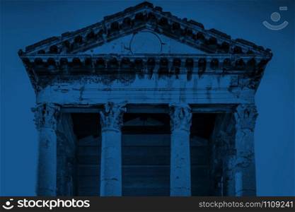 Roman temple of Augustus in Pula, Croatia. Color of the year 2020 bold classic blue duotone toned