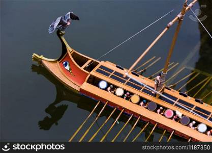 Roman war ship with rowers, miniature scene outdoor, europe. Mini figures with high detaling of objects, realistically diorama, toy model