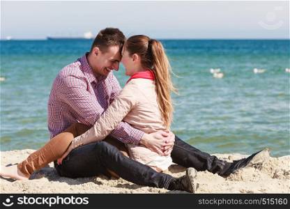 Romance, beautiful relantionship concept. Happy couple having date on beach near sea.. Happy couple having date on beach