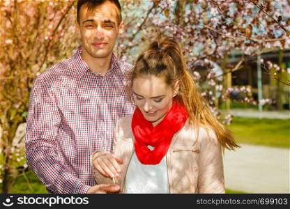Romance, beautiful relationship concept. Happy couple having romantic date in park during spring. Happy couple having romantic date in park