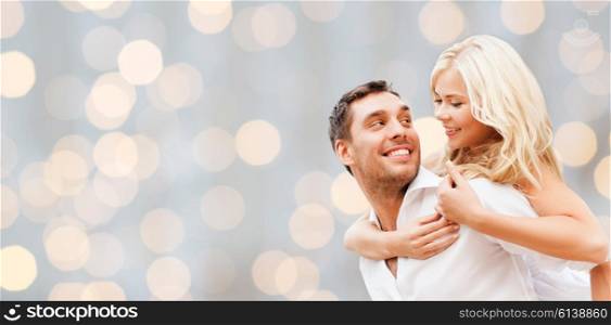romance, people, love and dating concept - happy couple over holidays lights background